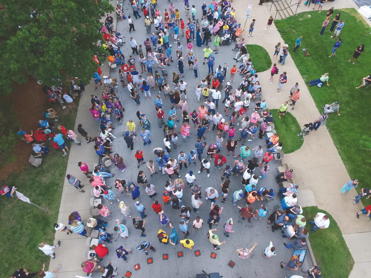 Aerial photo of large group of people standing on a street