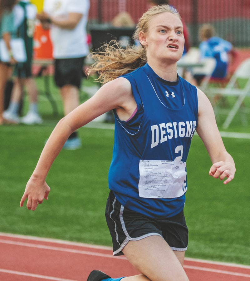 An athlete from Clever High School runs in a track and field race