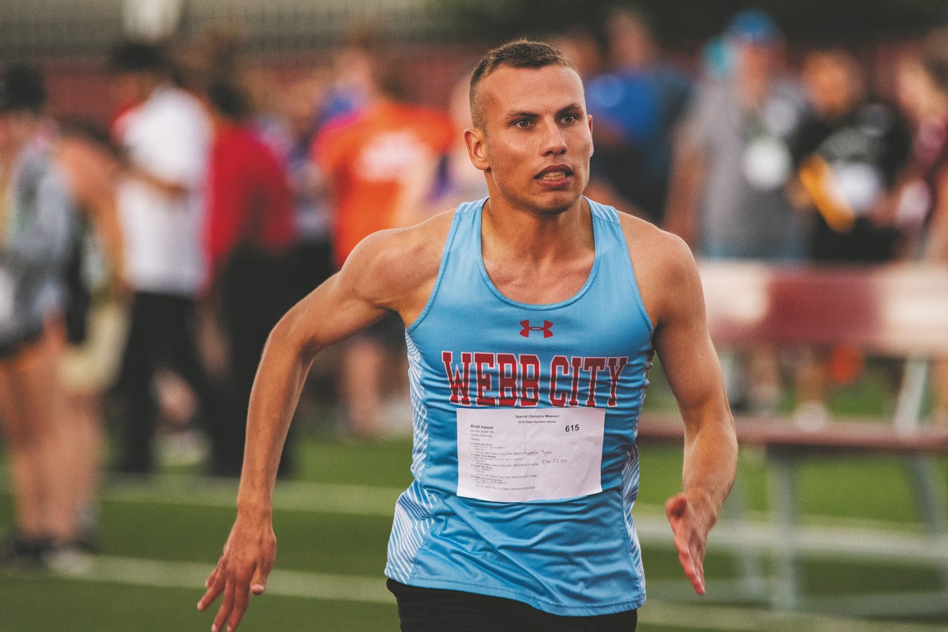 An athlete from Webb City runs in a track and field race with a look of focus on their face
