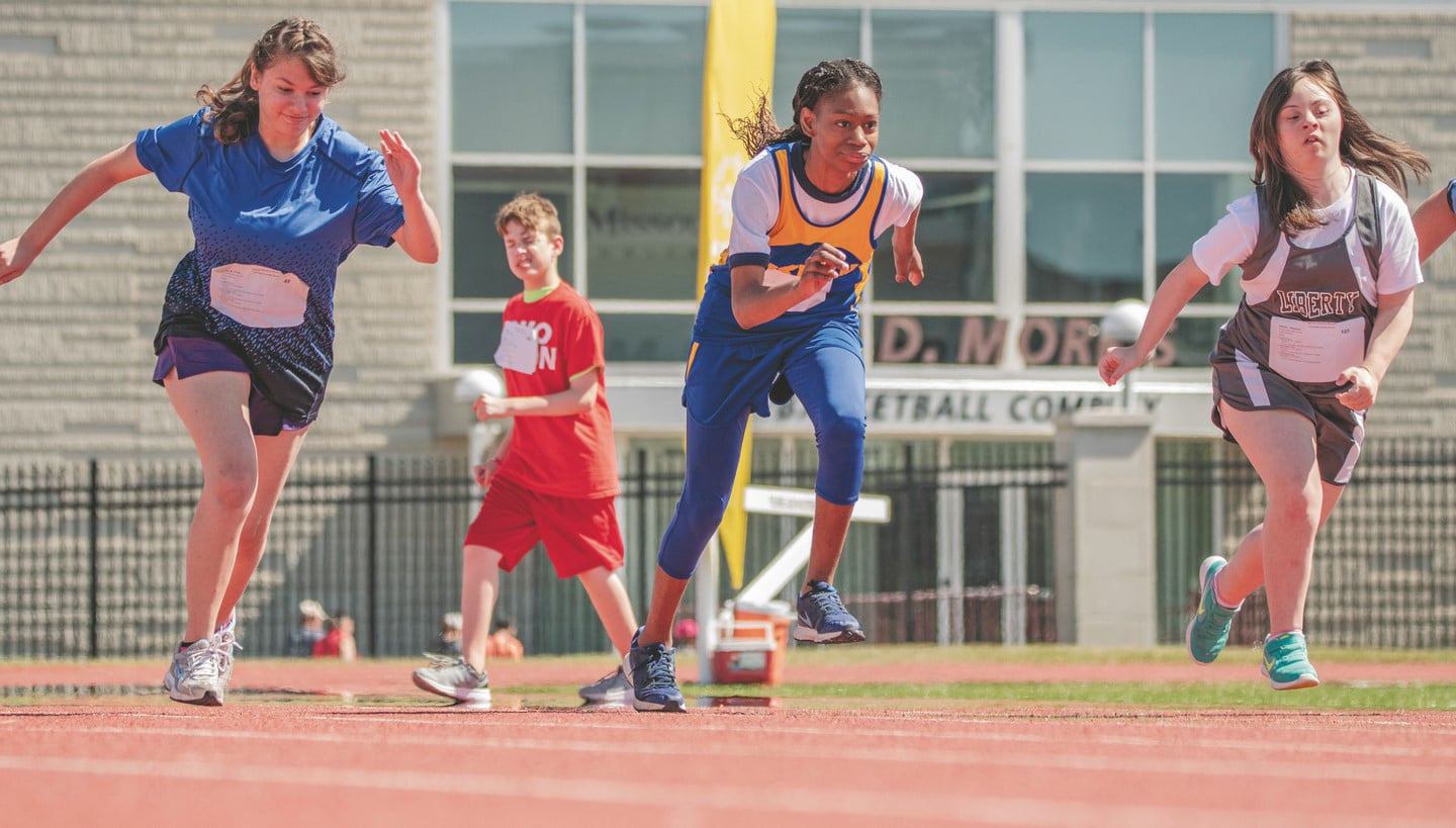 Three athletes break off the starting line during a track and field race