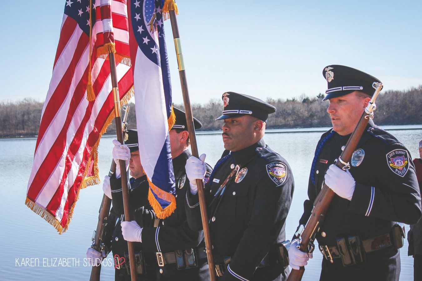 Police Officers pose while holding flags and rifles for opening ceremony at the Plunge