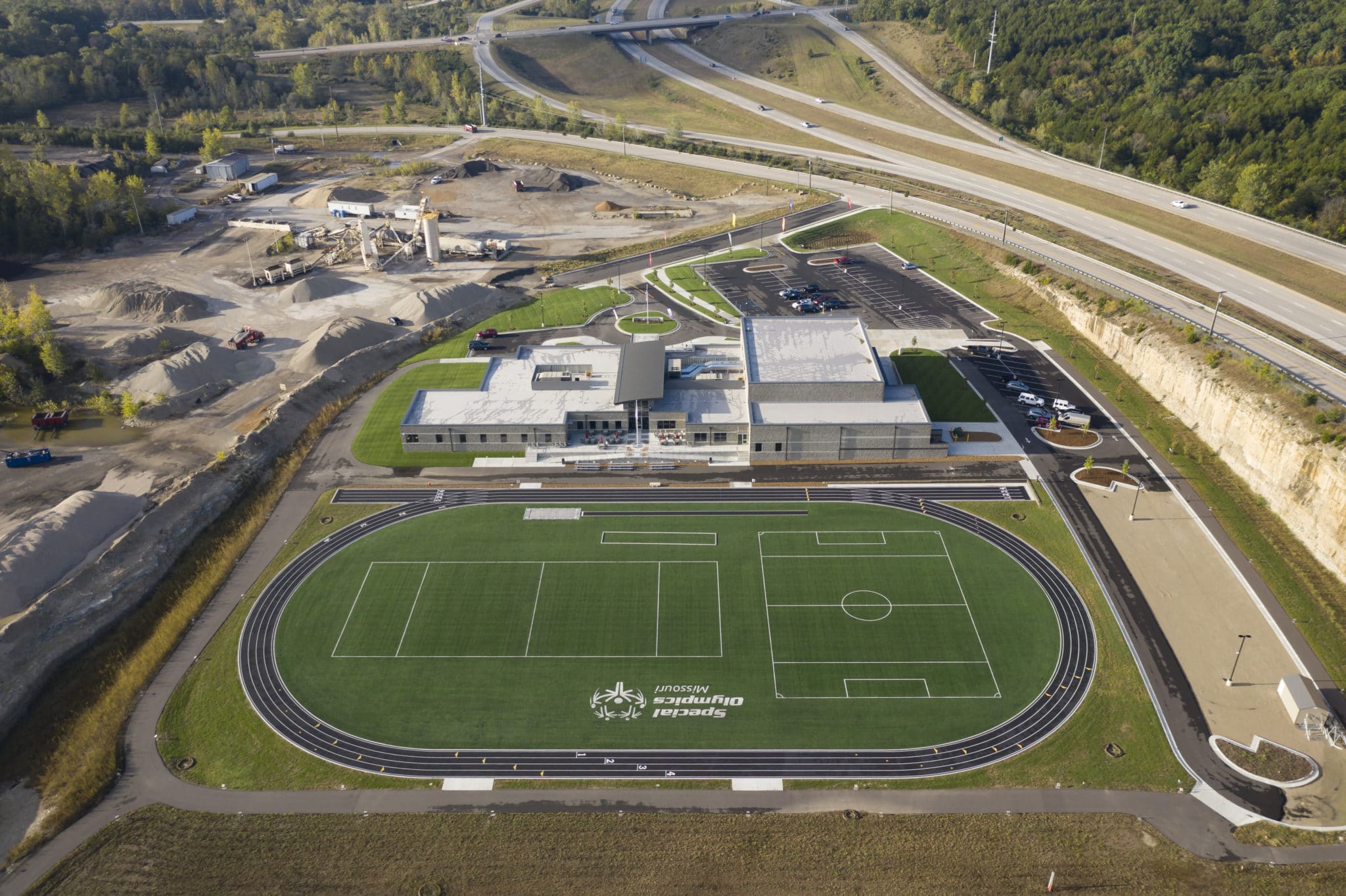 An aerial photo of the Training for Life Campus showing the turf field, track, and building