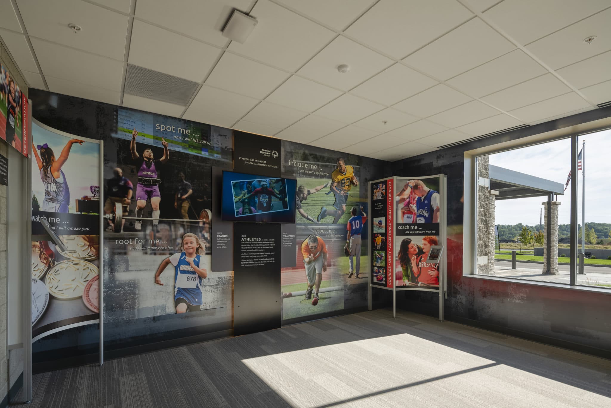 An interior photo of the Hall of Inspiration with photos of athletes on the walls at the Training for Life Campus