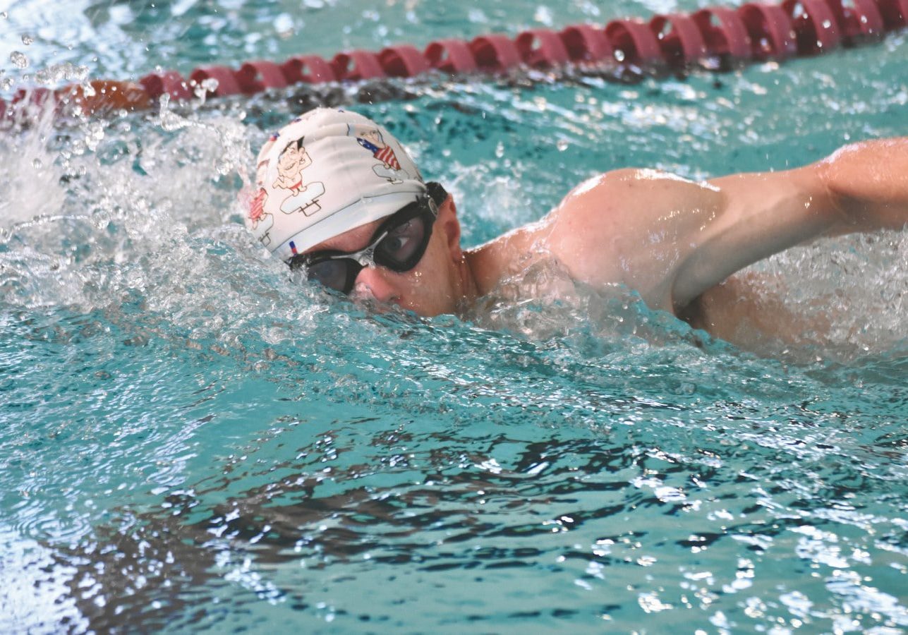 Bock, Devin Swimming (2) (Copy) A swimmer's head barely breaks out of the water, half of their face still submerged in water