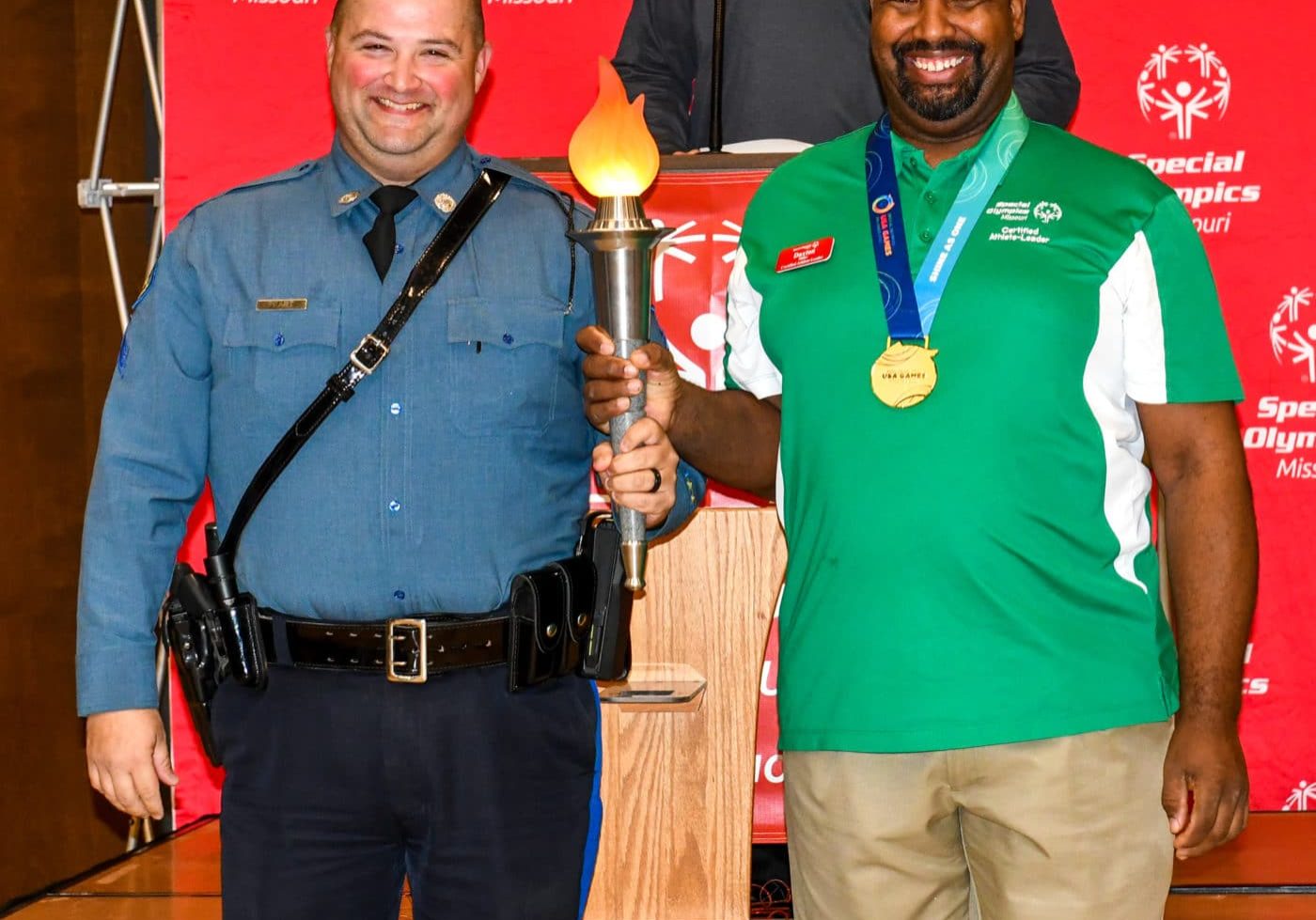 Joe Peart and Daxton Miller carry the Flame of Hope at the conclusion of the 2022 Law Enforcement Torch Run Celebration Lunch on Friday, Dec. 9, 2022 at the Training for Life Campus.
