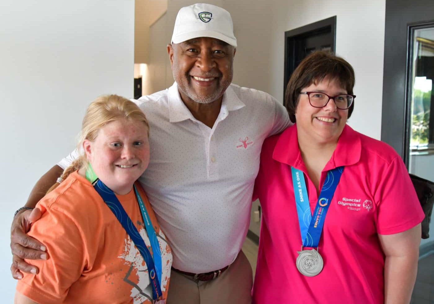 SOMO athletes Ozzie Smith and Abby Bax pose for a picture with Cardinals legend Ozzie Smith at Eagle Knoll Golf Club on Monday, July 18, 2022.